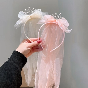 Detailed view of kids princess headband with sheer veil and pearl crown decorations