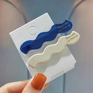 Elegant blue and cream wavy acetate hair clips set for women with gold lettering finish