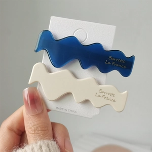 Detail showing blue and cream acetate wave hair clips with gold Barrette La France text