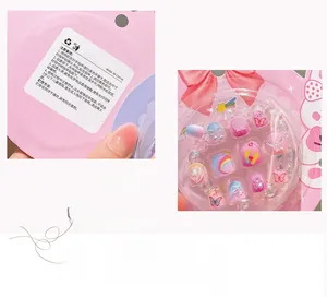 Detailed view of pink cartoon nail stickers set with rainbow and butterfly patterns