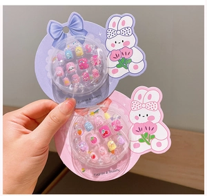 Close-up of children's nail art set featuring cute rabbit, strawberry and heart patterns