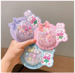 Close-up of three colorful cartoon nail sticker sets for kids with bunny designs
