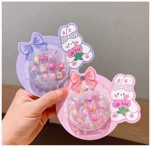 Close-up of cute cartoon nail art set for girls with colorful flower and rainbow patterns