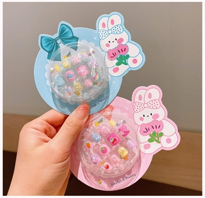 Close-up of cute cartoon nail art set for girls with colorful beads and storage box