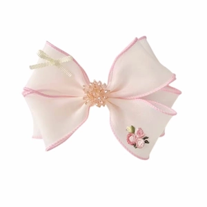 Pink embroidered floral bow hair clip with sheer fabric and beaded flower center