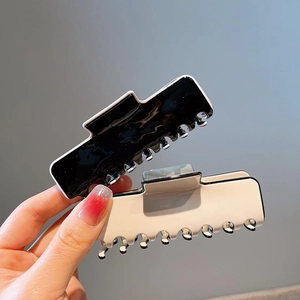 Minimalist large rectangular hair claws in glossy black and cream white for thick hair