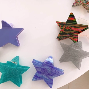 Star-shaped hair clips in purple, teal glitter and marble patterns for elegant updos