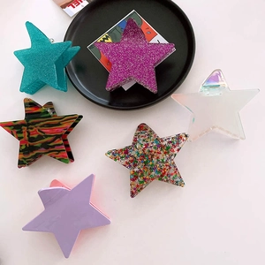 Set of six shimmering star hair claws in assorted colors and glitter patterns