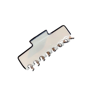 Large cream hair claw clip with black trim for thick hair styling in a minimalist design