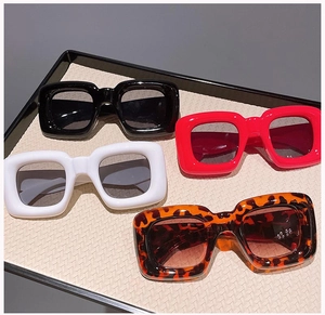 Detail showing four colors of chunky square sunglasses including red, black and leopard print
