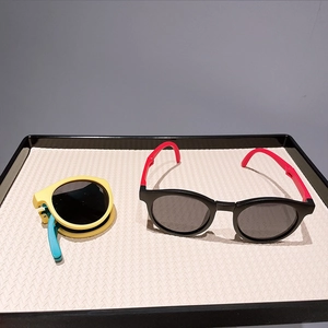 Detail view of foldable kids round sunglasses showing expanded and portable folded states