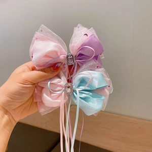 Double-layered mesh bow hair clips with long ribbons and gemstone centers for girls