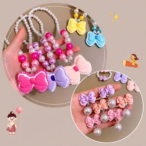 Parure collier et boucles d'oreilles clip pour enfants avec grand nœud en résine