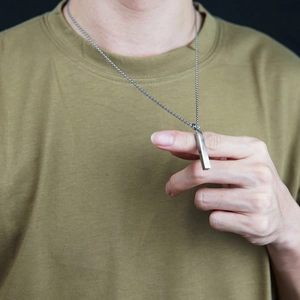 Minimalist square pillar pendant necklace in polished titanium steel worn by male model