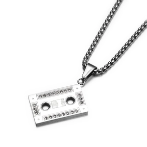 Macro shot of vintage cassette pendant with silver finish and sparkling zircon details