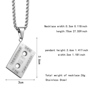 Detailed view of hip hop cassette tape pendant with rhinestones and box chain specs