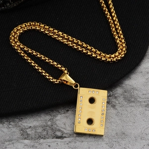 Detailed macro view of a golden cassette pendant with sparkling rhinestone accents