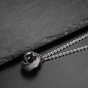 Detail of interlocking triple rings with sparkling rhinestones on a fine link chain
