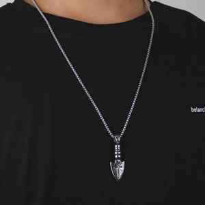 Hiphop arrow pendant necklace in polished titanium steel featuring an engraved cross design