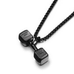 Detailed macro view of black stainless steel dumbbell pendant with 316L engraved markings