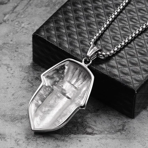 Detailed view of silver Hamsa hand pendant on a box chain inside a quilted jewelry box