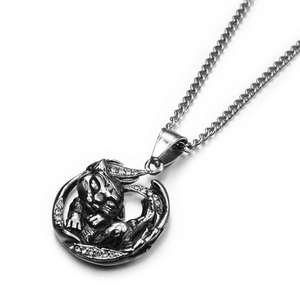 Detailed close-up of a vintage silver cat pendant with white rhinestones and a metal chain