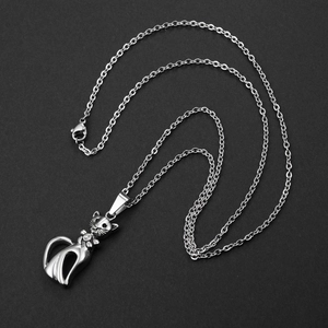 Hip hop style silver cat pendant necklace with crystal bowtie on black background