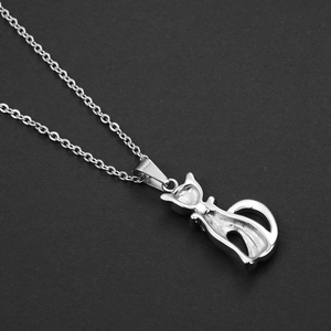 Macro detail of a silver hip-hop cat pendant necklace with polished hollow-out design