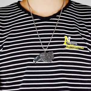 Silver eagle head pendant necklace in stainless steel worn by a male model