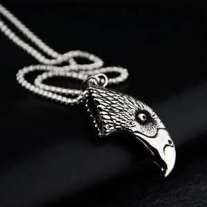 Macro shot of eagle head pendant featuring detailed silver feathers and vintage oxidation