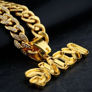 Iced out gold Cuban link chain with custom 3D SUAX letter pendant in hip hop style