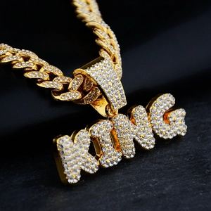 Iced out gold Cuban link chain with sparkling KING letter pendant in hip hop style