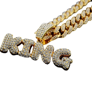 Iced out gold Cuban link necklace with rhinestone King letter pendant in hip hop style