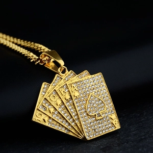 Close-up of iced out gold spade royal flush poker pendant with cuban chain on black leather