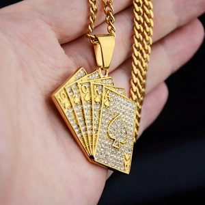 Macro view of gold iced-out royal flush poker pendant with crystal rhinestones