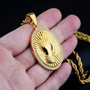 Hip hop style gold praying hands pendant necklace with white crystals on a rope chain