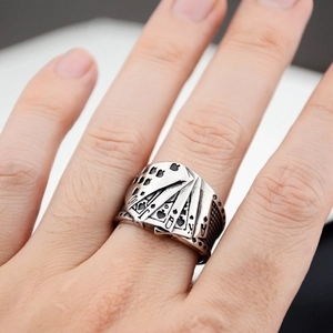Macro shot of vintage titanium steel ring featuring poker royal flush embossed patterns