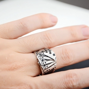 Macro detail of retro punk royal flush poker ring in black stainless steel