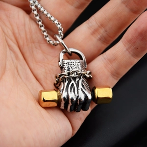 Detail of silver and gold boxing glove pendant with dumbbell and box chain necklace