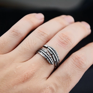 Retro hiphop feather ring in vintage silver titanium steel worn on model hand