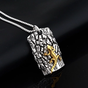 Creative gecko lizard pendant on a textured silver rectangle with a gold accent box chain