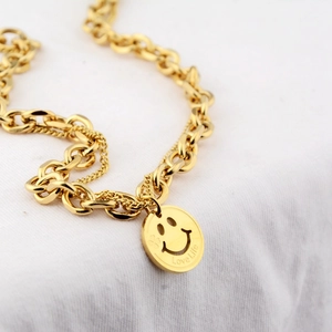 Detail of gold chunky layered chain necklace with hollow smiley face and Love Life pendant