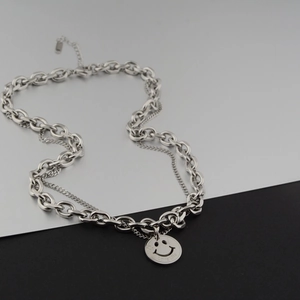 Detailed macro view of silver double-layer chain necklace with Love Life smiley pendant