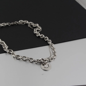 Detail of silver double-layered chunky chain necklace with 'Love Life' smiley pendant
