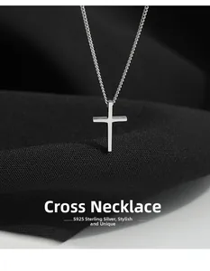 Macro shot of minimalist S925 sterling silver cross pendant on thin O-chain necklace