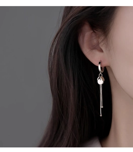 Close-up of S925 sterling silver drop earrings with round discs and elegant long tassels