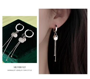 Detail view of S925 sterling silver tassel earrings with polished round discs