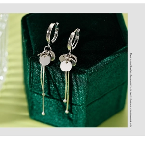 Detail of S925 sterling silver drop earrings with discs on green velvet box