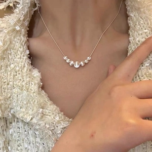 Close-up of S925 sterling silver necklace with cat eye beads on a female model