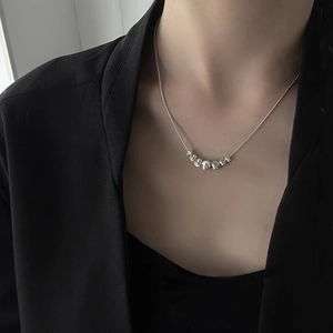 Detail of S925 silver snake chain with gradient polished beads on neck
